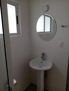 a white bathroom with a sink and a mirror at Sierra 2 in Acapulco