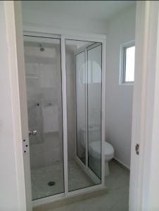 a bathroom with a glass shower and a toilet at Sierra 2 in Acapulco