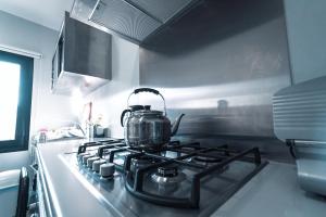 a tea kettle sitting on top of a stove in a kitchen at Peares Center Chalet in Carballedo