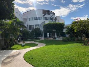 a building with a walkway in front of a park at Sierra 2 in Acapulco