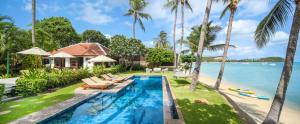 an image of a villa with a swimming pool and the ocean at Ban Haad Sai - Beachfront Private Villa in Bangrak Beach