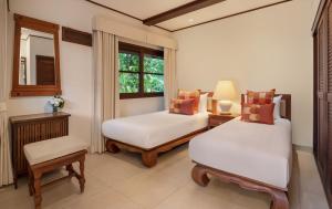 a bedroom with two beds and a window at Ban Haad Sai - Beachfront Private Villa in Bangrak Beach +46 photos