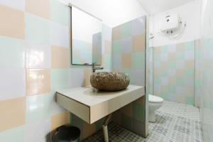 a bathroom with a sink and a toilet at Dream CoWork Hotel in Kuta Lombok