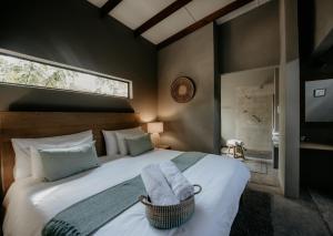 a bedroom with a large bed with two towels on it at Dream of Africa Bush Lodge in Marloth Park