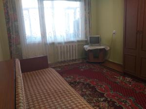 a room with a bed and a laptop on a window at Уютная квартира не далеко от центра города in Penza