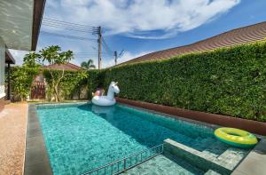 a swimming pool with a inflatable horse in a backyard at A-One Pool Villa Aonang Krabi in Ao Nang Beach