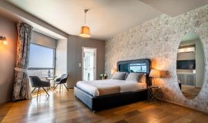a bedroom with a large bed and a mirror at My Jerusalem View in Jerusalem