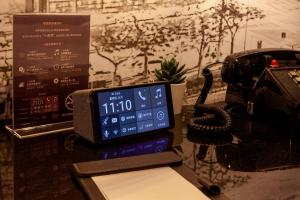 a phone sitting on a table next to a telephone at CU Hotel Kaohsiung in Kaohsiung