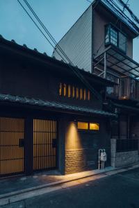 a building with a light on the side of it at Noboru House Kyoto in Kyoto