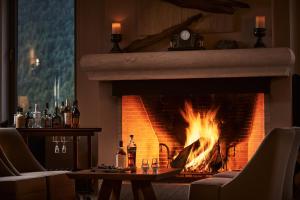 a fireplace that has a fire place in it at Grand Forest Metsovo - Small Luxury Hotels of the World in Metsovo