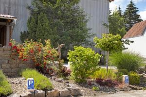 a garden in front of a house with flowers at Ferienwohnung Bodensee in Schnerkingen