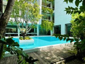 a swimming pool in front of a building at POR Daowadung - NO PARKING in Chiang Mai