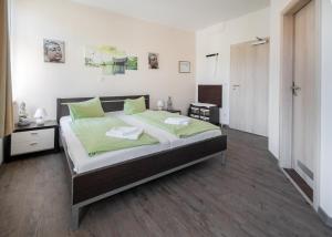 a bedroom with a large bed with green sheets at Villa Altstadtperle Erfurt in Erfurt