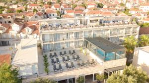 an aerial view of a building with a swimming pool at Hotel Osam - Adults Only in Supetar
