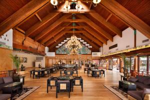 a large lobby with tables and chairs and a chandelier at Herbert Samuel Royal Shangri-La Eilat in Eilat