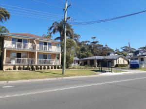 a house on the corner of a street at Dolphins of Mollymook Motel in Mollymook