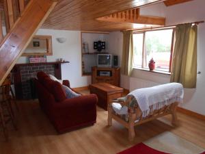 a living room with a couch and a fireplace at Birchdale Cottage in Rathdrum