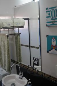 a bathroom with a sink and a mirror at AnaLuiza Smarthome in Sao Jose do Rio Preto