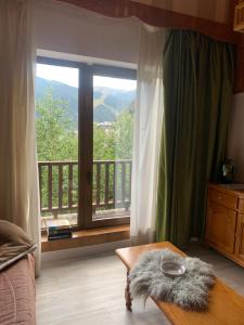 a bedroom with a large window with a view of a balcony at ABELLETES - K31 Deusol - Vall d'Incles - Soldeu in Incles