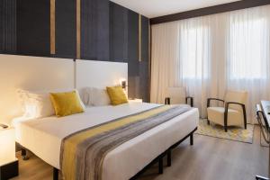 Postel nebo postele na pokoji v ubytování Savhotel Fiera Bologna