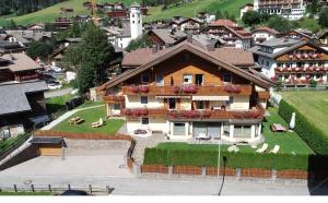 a large house on a hill in a town at Residence Kramhuter in Sesto