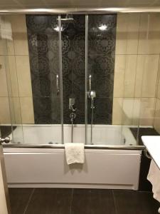 a bathroom with a bath tub with a towel on it at Esila Hotel in Ankara