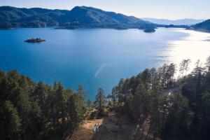 a view of a large body of water with trees at Grand Forest Metsovo - Leading Hotels of the World in Metsovo