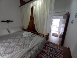 a bedroom with a bed and a window at Villa Evdokia in Kalymnos