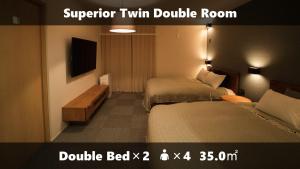 a hotel room with two beds and a television at Vieuno Stay Hakata 1 in Fukuoka