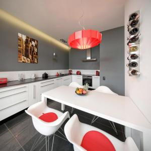 a kitchen with a white table and white chairs at Apartament ST1 in Cieszyn