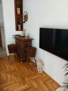 a living room with a large flat screen tv on a wall at Apartments iris in Brela