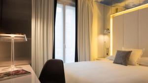 Postel nebo postele na pokoji v ubytování Nouvel Hôtel Eiffel