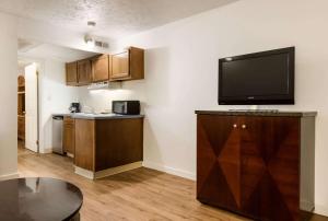 a kitchen with a flat screen tv on the wall at Econo Lodge Inn & Suites Lake Harmony - Pocono Mountains Area in White Haven