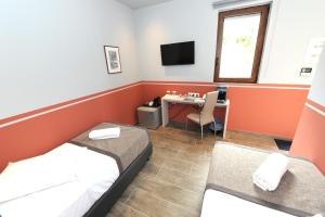 a room with two beds and a television at Castle View Bungalows in Mystras