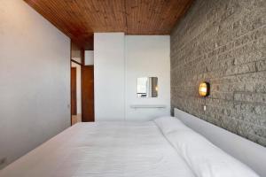 A bed or beds in a room at Residence La Cava Trilocale 1d