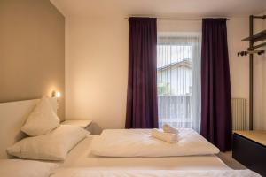 a hotel room with a bed with a window at Apt Hofer Barbara in Villabassa