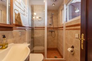 a bathroom with a shower and a toilet and a sink at Casa Mia in Almuñécar +14 photos