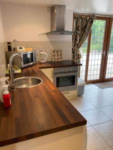 a kitchen with a sink and a microwave at The little house in West Hanningfield