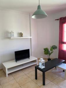 a living room with a tv and a table at Berlin Lovely in Gran Tarajal