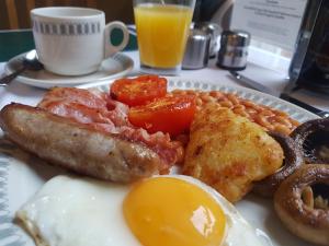 a plate of breakfast food with eggs sausage and beans at The Bahamas in Torquay