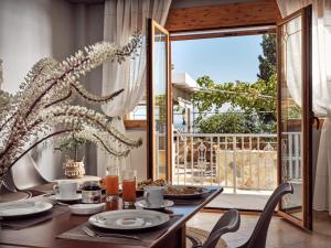 a dining room with a table with food and a window at Lithakia Balcony Villa in Lithakia
