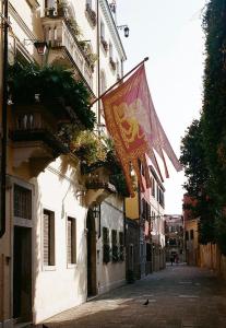 a flag hanging on the side of a building at Ca' del Pittor Apartments in Venice