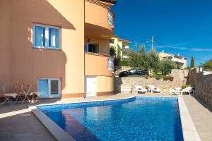 a villa with a swimming pool in front of a house at La Vista apartments in Salatić