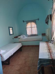 A bed or beds in a room at Nubian Holiday House Aswan