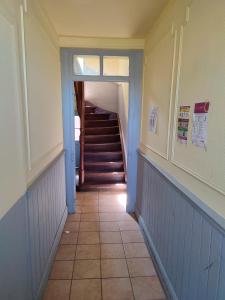 a hallway with a staircase with blue walls and a tile floor at *** les loges de la friche DMC *** in Mulhouse