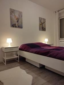 a bedroom with a bed and two pictures on the wall at *** les loges de la friche DMC *** in Mulhouse