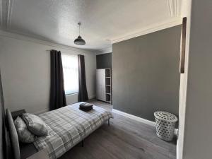 a bedroom with a bed and a window at The Grey House in Blythe