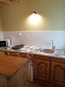 a kitchen with a sink and a counter top at La villa verte in Beaulieu
