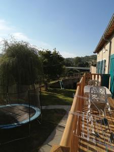 a balcony with a fence and a swing at La villa verte in Beaulieu