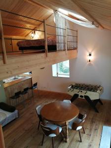 a room with a table and a bed and a loft at La villa verte in Beaulieu